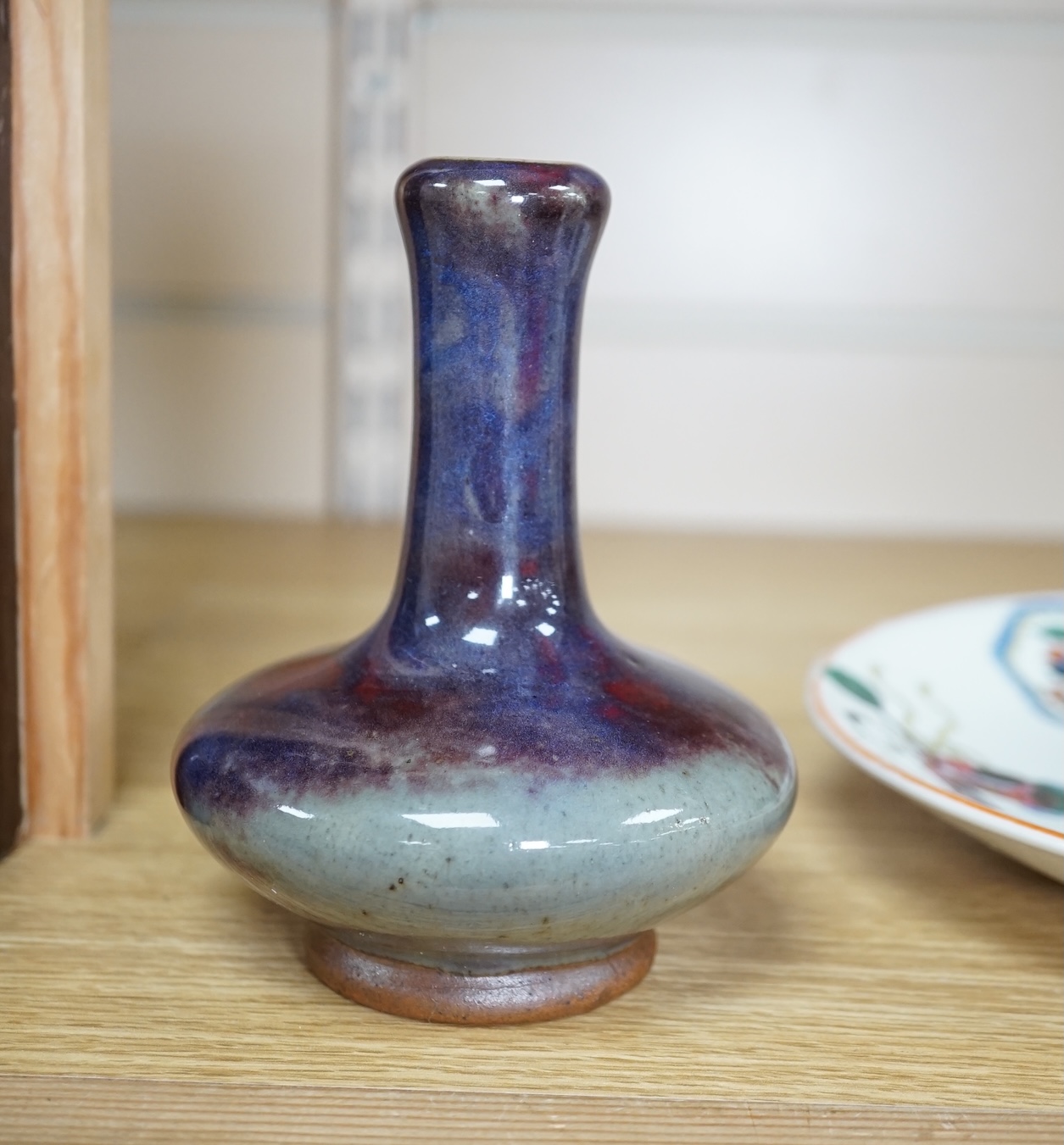 A Japanese porcelain seated figure of Kwannon, a flambé vase and a figural saucer dish, saucer dish 21.5 cm diameter. Condition - fair to good